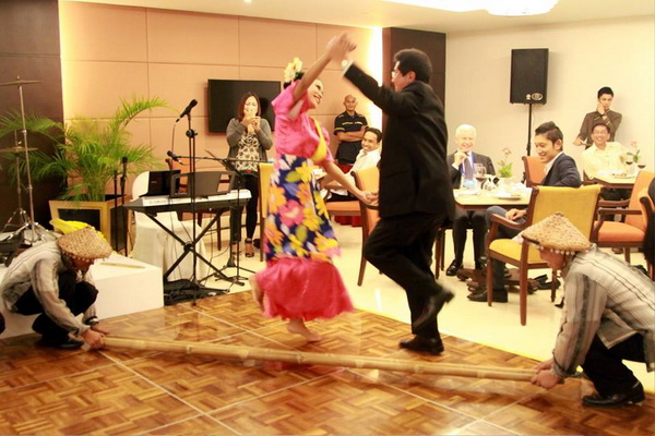 Vice-Minister of Energy and Mines Guillermo Shinno Huamani of Peru trying the Tinikling Dance during the Welcome Dinner for the Mining Task Force Meeting hosted by the MGB-DENR.